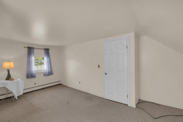 interior space with a baseboard heating unit, lofted ceiling, and carpet floors