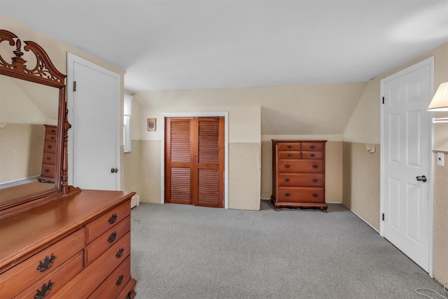 bedroom with a closet, carpet, and vaulted ceiling
