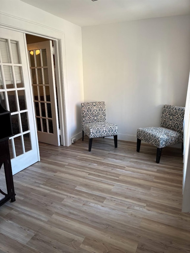 unfurnished room featuring wood finished floors and baseboards