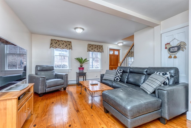 living room featuring light wood finished floors and stairs