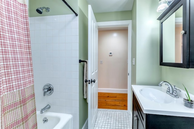bathroom featuring vanity, baseboards, shower / bath combo, and tile patterned flooring