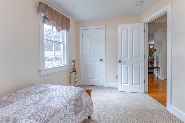 carpeted bedroom featuring baseboards