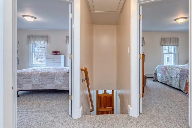 corridor featuring carpet floors and a baseboard radiator