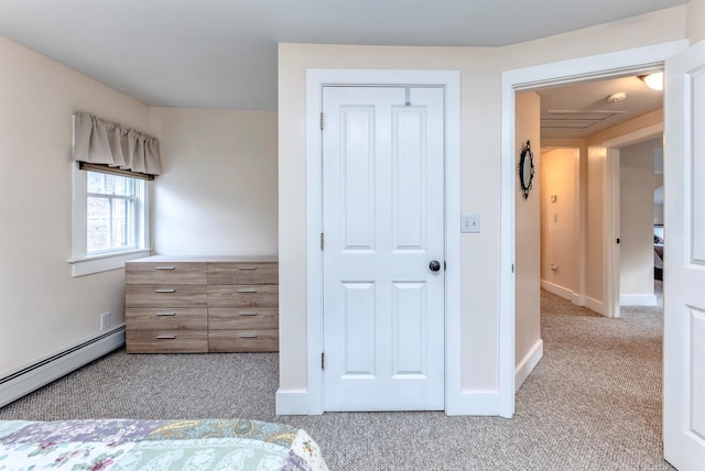 unfurnished bedroom with carpet flooring, baseboards, and a baseboard radiator