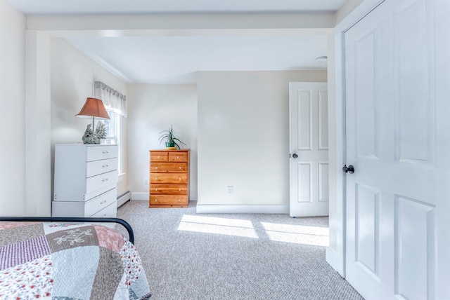 carpeted bedroom with baseboard heating and baseboards