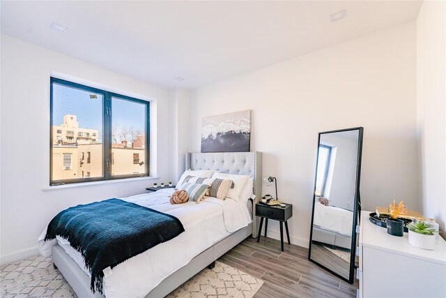 941 57th St Unit 4B, Brooklyn, NY 11219 - bedroom with baseboards and light wood finished floors