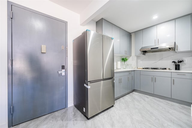 941 57th St Unit 4B, Brooklyn, NY 11219 - kitchen with decorative backsplash, under cabinet range hood, appliances with stainless steel finishes, and gray cabinetry