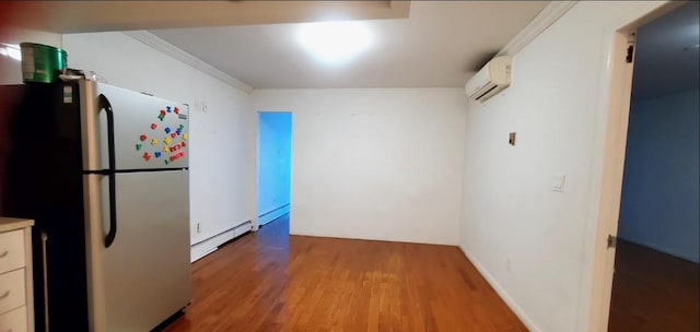 31-12 Union St Unit 4A, Flushing, NY 11354 - kitchen featuring an AC wall unit, freestanding refrigerator, a baseboard heating unit, wood finished floors, and ornamental molding