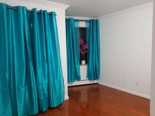 31-12 Union St Unit 4A, Flushing, NY 11354 - empty room with wood finished floors, crown molding, and a baseboard heating unit
