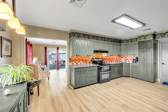 kitchen with light wood finished floors, decorative backsplash, double oven range, under cabinet range hood, and visible vents