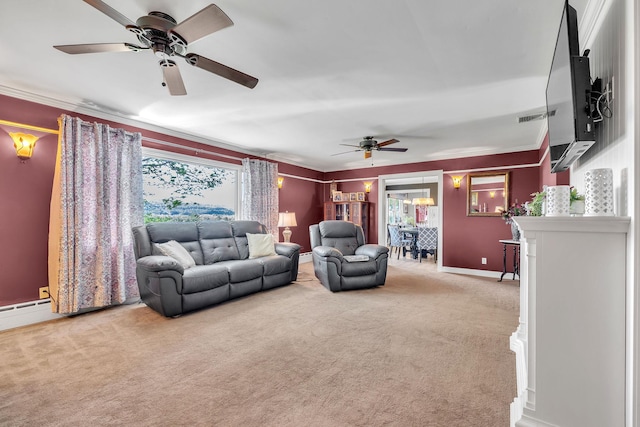 living area featuring baseboards, a ceiling fan, carpet flooring, and ornamental molding