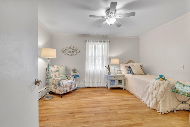 bedroom featuring crown molding, baseboard heating, a ceiling fan, and wood finished floors