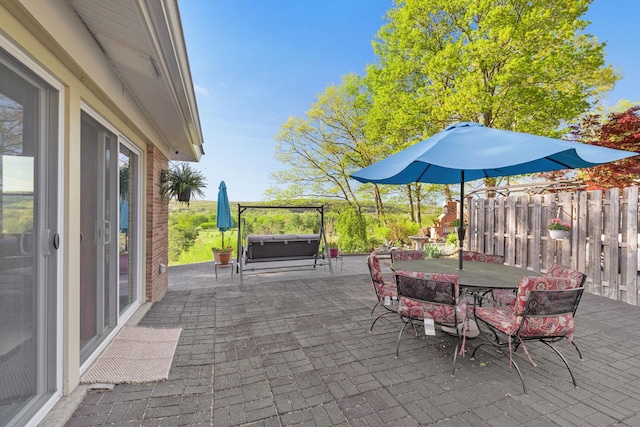 view of patio featuring fence and outdoor dining space