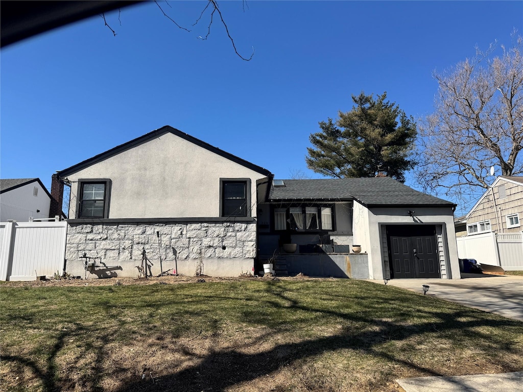 ranch-style home featuring stucco siding, concrete driveway, an attached garage, and fence
