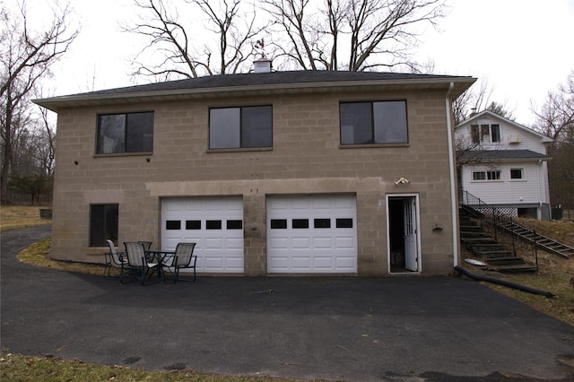 191 Gables Rd, Narrowsburg, NY 12764 - view of front of home featuring a garage, driveway, stairway, and a chimney