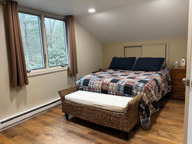 191 Gables Rd, Narrowsburg, NY 12764 - bedroom featuring a baseboard heating unit, vaulted ceiling, wood finished floors, and recessed lighting