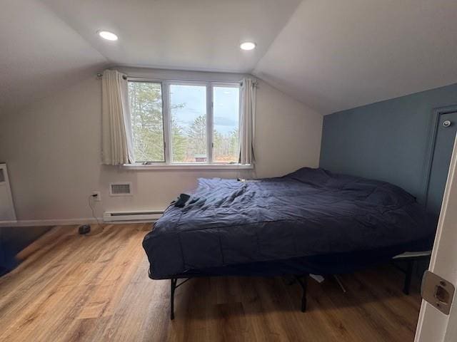 191 Gables Rd, Narrowsburg, NY 12764 - bedroom with vaulted ceiling, wood finished floors, a baseboard heating unit, baseboards, and recessed lighting