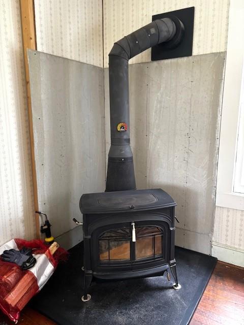 191 Gables Rd, Narrowsburg, NY 12764 - detailed view of wallpapered walls, a wood stove, and wood finished floors