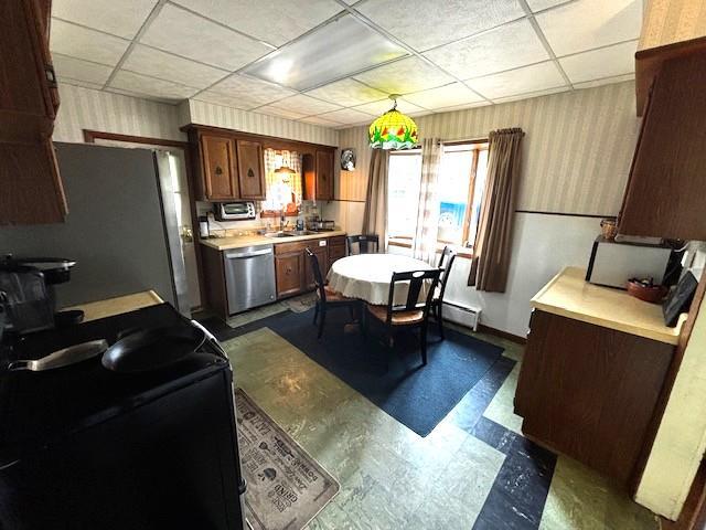 191 Gables Rd, Narrowsburg, NY 12764 - kitchen with stainless steel appliances, dark flooring, light countertops, baseboard heating, and wallpapered walls