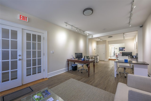 office with french doors, rail lighting, baseboards, and wood finished floors