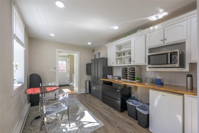 kitchen featuring white cabinetry, fridge, open shelves, stainless steel microwave, and wood counters