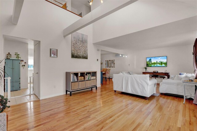 18 Saint George Dr, Shirley, NY 11967 - living room with light wood-type flooring, baseboards, and a towering ceiling