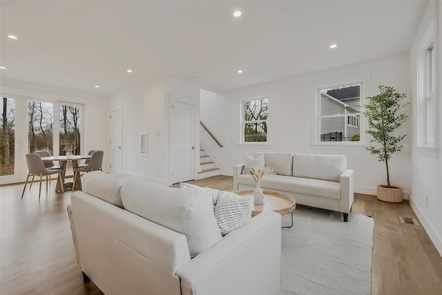 550 Madison Ave, Greenport, NY 11944 - living area with light wood-style floors, stairs, recessed lighting, and baseboards