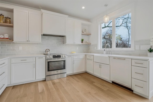 550 Madison Ave, Greenport, NY 11944 - kitchen featuring open shelves, stainless steel electric range oven, white cabinets, light wood-type flooring, and tasteful backsplash