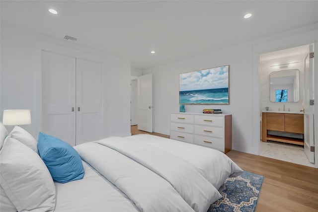 550 Madison Ave, Greenport, NY 11944 - bedroom featuring light wood-style flooring, recessed lighting, a closet, and connected bathroom