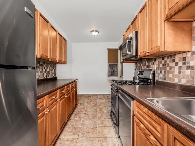 2166 Bronx Park E Unit 1G, Bronx, NY 10462 - kitchen with a sink, tasteful backsplash, stainless steel appliances, light tile patterned floors, and dark countertops