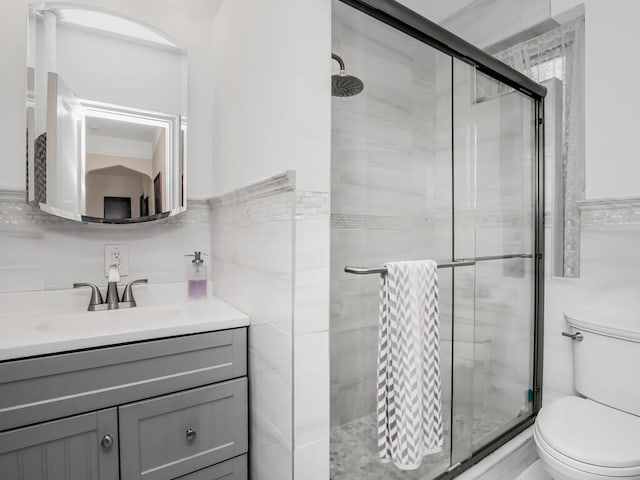 2166 Bronx Park E Unit 1G, Bronx, NY 10462 - bathroom with vanity, toilet, tile walls, and a shower stall