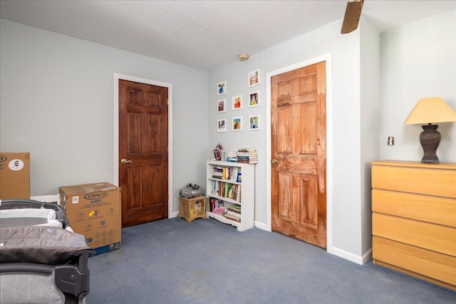 bedroom featuring baseboards and carpet