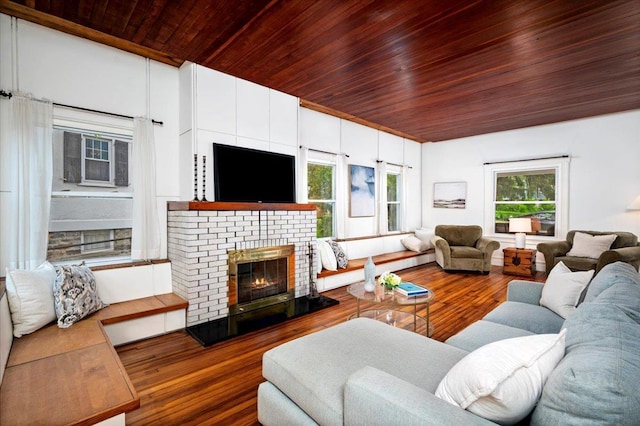 living room featuring wooden ceiling, wood finished floors, and a fireplace