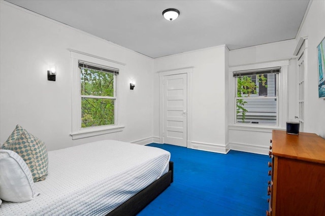 bedroom featuring multiple windows and baseboards