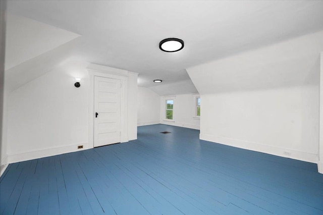 bonus room with vaulted ceiling, baseboards, and dark wood finished floors