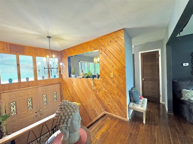 15 Highland Ave, Chestnut Ridge, NY 10977 - dining area featuring baseboards, wood walls, hardwood / wood-style flooring, and an inviting chandelier