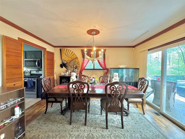 15 Highland Ave, Chestnut Ridge, NY 10977 - dining area with ornamental molding, an inviting chandelier, and wood finished floors
