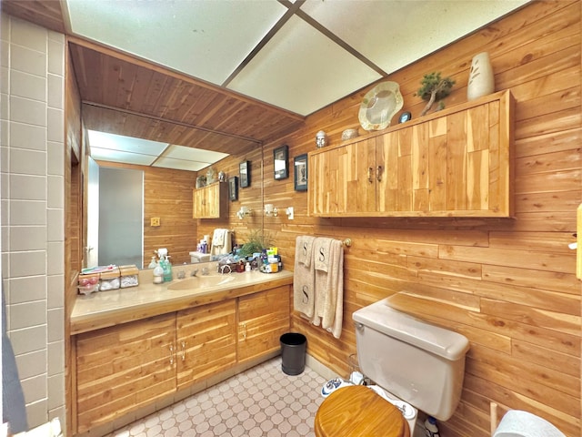 15 Highland Ave, Chestnut Ridge, NY 10977 - bathroom featuring wooden walls, toilet, and vanity
