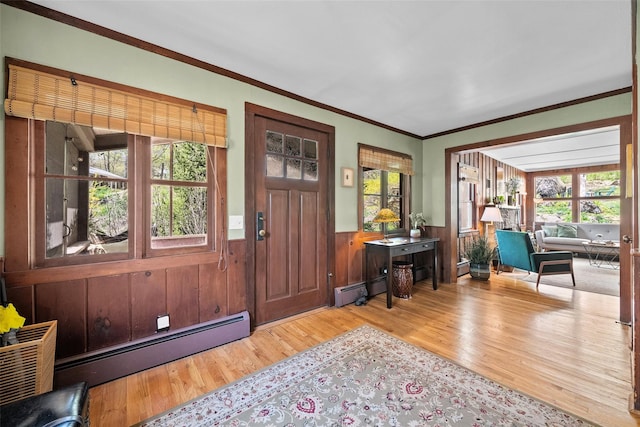 35 Riverview Trl, Croton-On-Hudson, NY 10520 - entrance foyer featuring a baseboard radiator, wood finished floors, wainscoting, plenty of natural light, and crown molding
