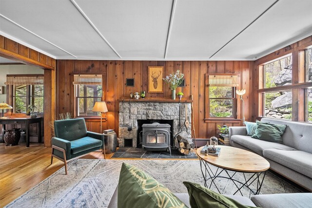 35 Riverview Trl, Croton-On-Hudson, NY 10520 - living room with a wood stove, wood finished floors, and wooden walls