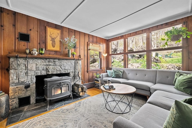 35 Riverview Trl, Croton-On-Hudson, NY 10520 - living area featuring wood walls, a wood stove, baseboard heating, and wood finished floors