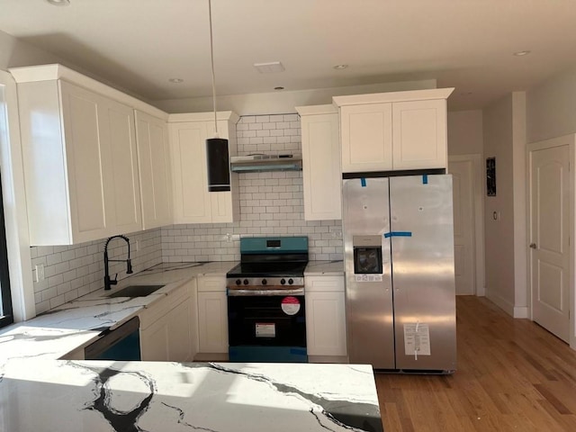 3425 Boller Ave, Bronx, NY 10475 - kitchen with a sink, light stone countertops, under cabinet range hood, stainless steel appliances, and white cabinets