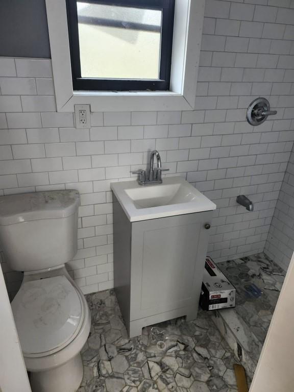 3425 Boller Ave, Bronx, NY 10475 - full bath with tile walls, marble finish floor, a tile shower, toilet, and vanity
