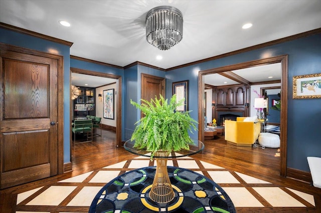 foyer entrance featuring crown molding, baseboards, and recessed lighting