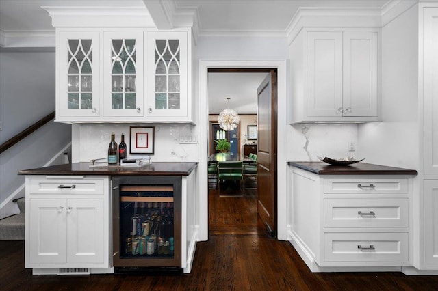bar featuring crown molding, dark wood-style floors, stairs, and wine cooler