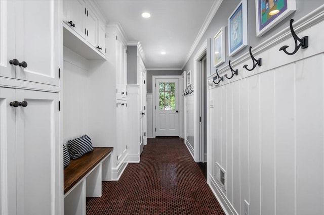 mudroom featuring crown molding, a decorative wall, recessed lighting, and visible vents