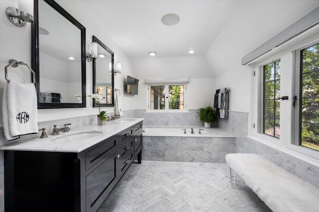 full bathroom with a sink, a bath, and a wealth of natural light