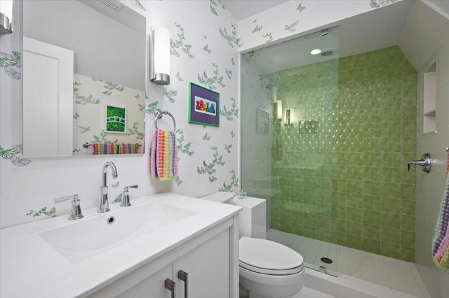 full bathroom with vanity, wallpapered walls, toilet, and tiled shower