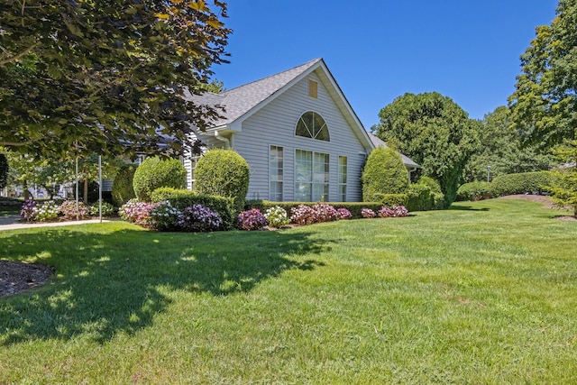 view of property exterior featuring a lawn