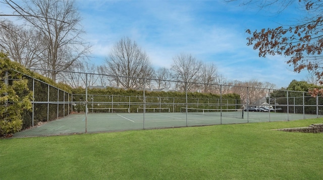 view of sport court featuring a lawn and fence